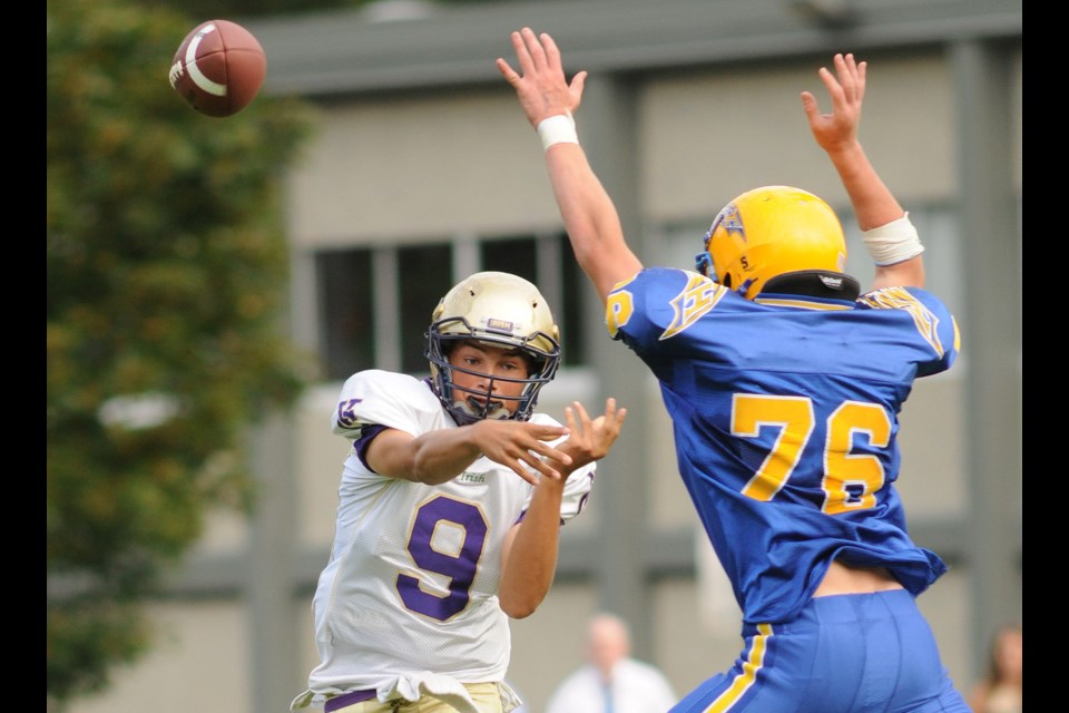 Giordy Belfiore (No. 9) makes a pass as he's rushed by a Mt. Boucherie Bear Sept. 6 at O'Hagan Field.