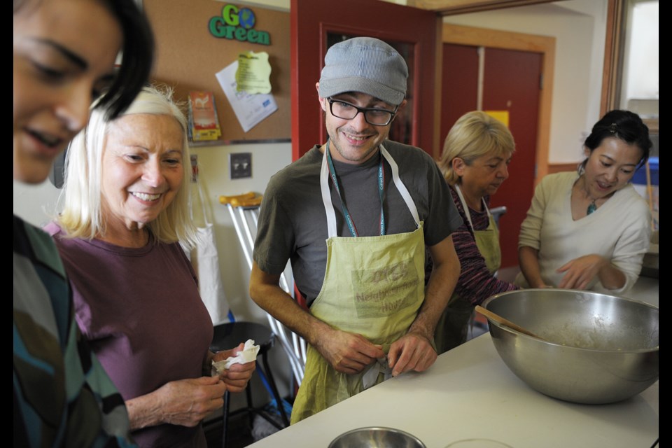 Leading the cornbread-making team during a free cooking class at the Gordon Neighbourhood House this past Saturday is cook Andrew Christie. The cooking class was part of the West End Food Festival held at the house.