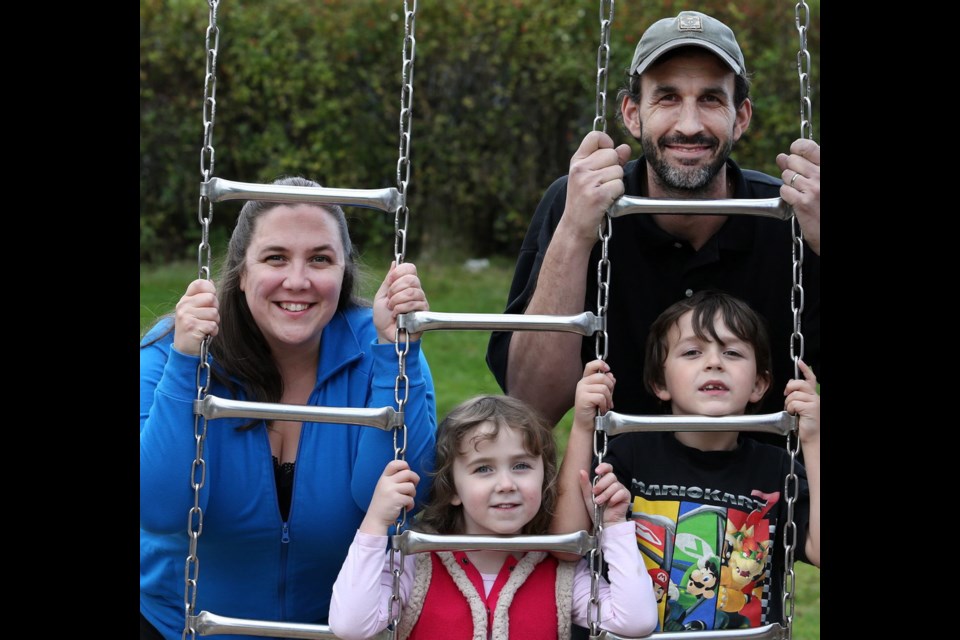 The Ujfalusi family, from left, seven-year-old Cameron, mom Tiffany, dad John and four-year-old Jenna at their home. They participate in the Saturday morning family fitness sessions at Vic West Community Centre.