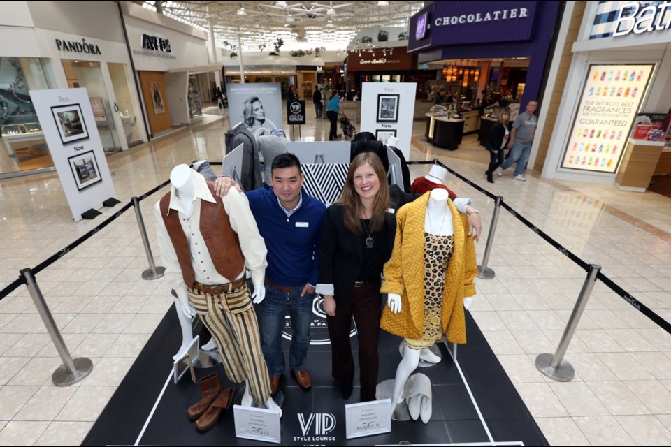 Mayfair Shopping Centre general manager Ken Hoang and marketing director Julie McCracken size up fashions from the 1960s and 1970s at a display designed to show shoppers the changing styles over 50 years.