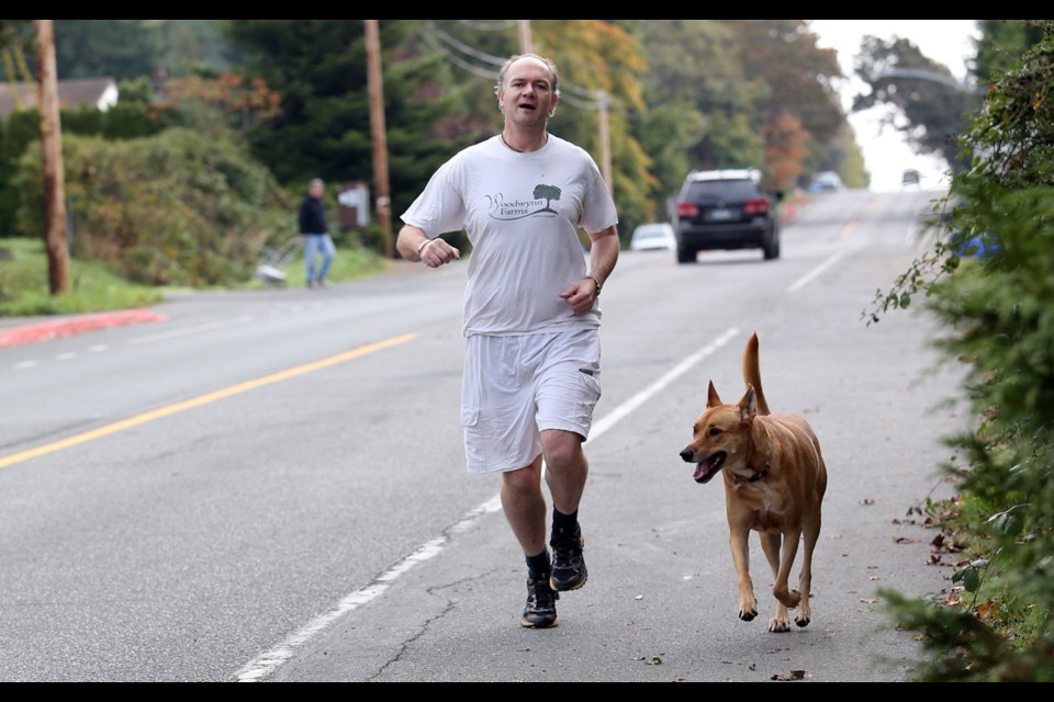 Life coach Don Goodeve, 45, training with his dog Bodhi, is running the half-marathon at the GoodLife Fitness Victoria Marathon on Sunday in the name of Woodwynn Farms.