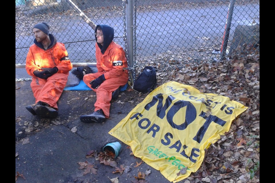 Closed: Greenpeace activists have chained themselves to the front gate of Burnaby's Kinder Morgan Westbridge Marine terminal, shutting down the facility.