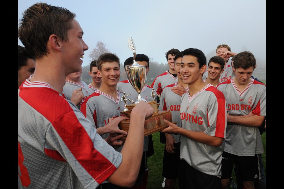 The Lord Byng Grey Ghost hoist the Gary Haensgen Cup as the 2013 senior boys soccer city champions.