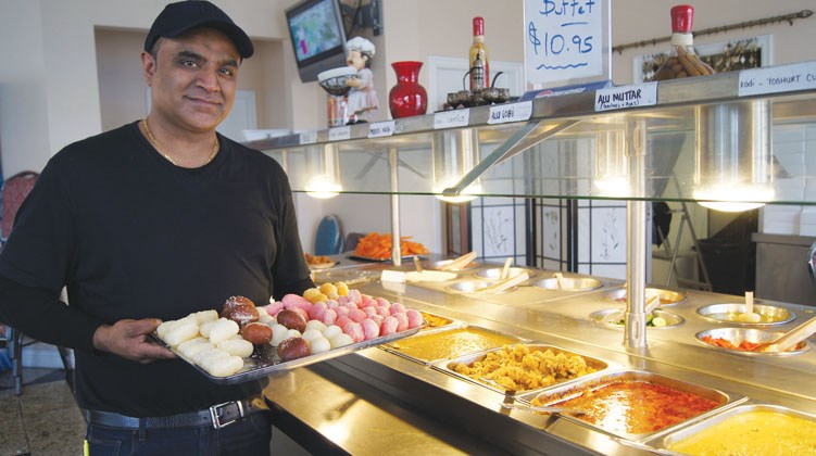 Graeme Wood/Special to the News Sarb Pabla, manager of Himalaya Restaurant, displays his popular Indian food buffet during the lunch hour crunch.