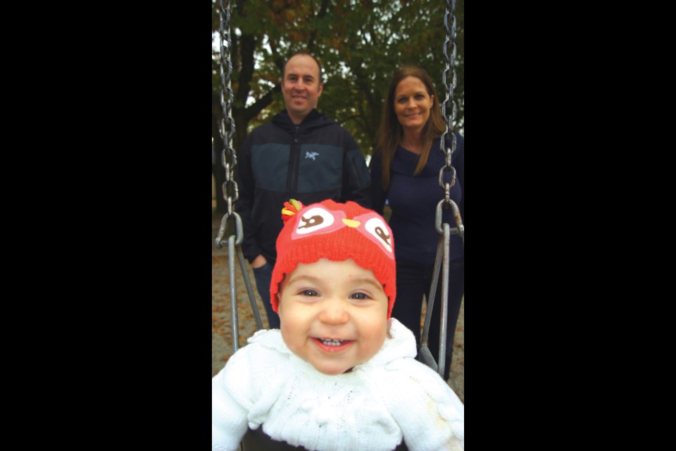 Graeme Wood/Special to the News Dave and Colette Young, with baby Brooke, enjoy a day at the playpark. Dave enjoys living close to the Canada Line, the city centre and to the park.