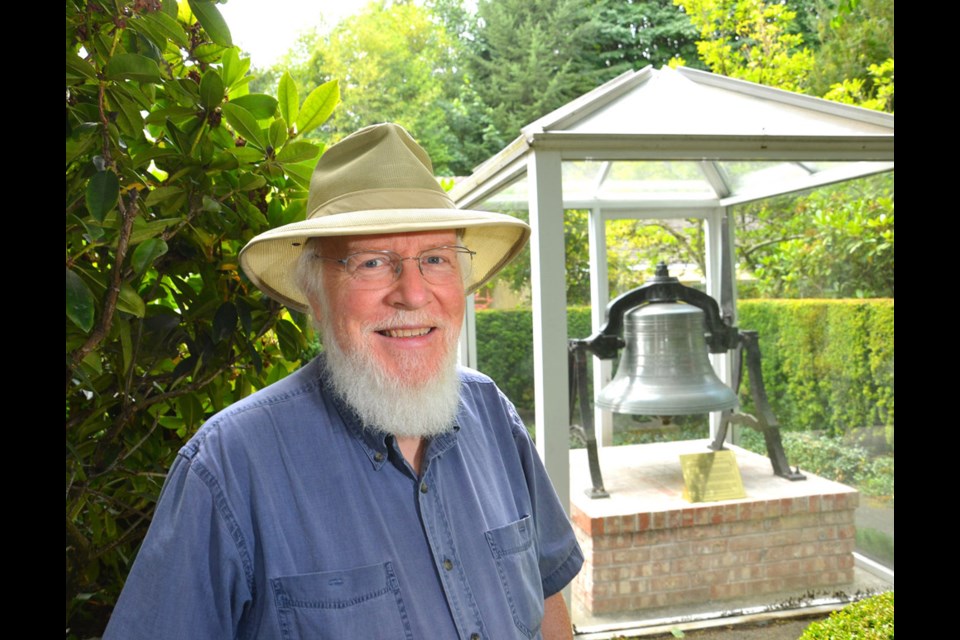 Local historian Archie Miller in front of the bell from the old B.C. Penitentiary, one of many historic features found in the Sapperton neighbourhood. The bell was used to signal shift changes at the prison and is now kept in a case in Glenbrook Ravine Park.