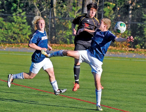 Sutherland's Cole Keffer (left) watches teammate Connor Dennehy and West Vancouver's Leonardo Braz battle during a North Shore AAA game Thursday. Sutherland lost 2-1 in an overtime shootout but still finished first in the league and will host AA league winners Sentinel in the North Shore championship final Tuesday, Oct. 29at 3:30 p.m.