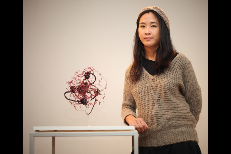 Olive Leung, artist in residence at the Burnaby Arts Council, with some of her work in the Synthetic Garden exhibition, on now at Deer Lake Gallery.