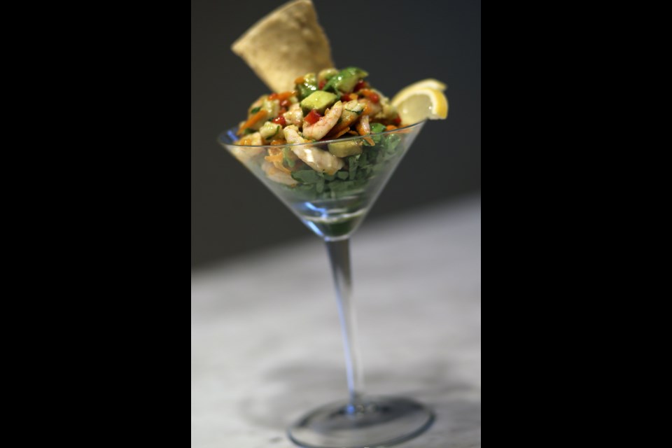 Lovely shrimp and avocado salad is served in a martini glass.
