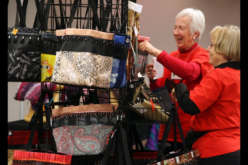 Shopping for a cause: Royal City Gogos Penny Perry and Carolyn Neighbor look at purses at the Artisan Crafts for Africa at last year's Artisan Crafts for Africa Sale. This year's sale is one of our Top 5 picks for the weekend in New West.