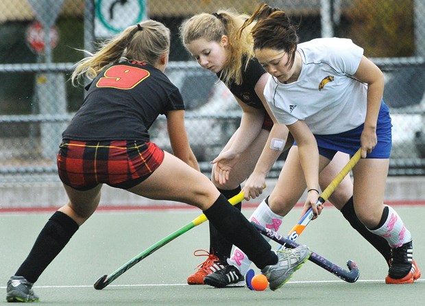 West Vancouver's Lucy Mavko (left) and Clara Grote put the squeeze on Handsworth's Melissa Henry in the North Shore AAA final played Nov. 3 at Rutledge Field. Handsworth won 4-1 and will look to earn their thrid straight B.C. title at the provincial championships running Nov. 13-15 in Burnaby.