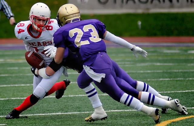 The Vancouver College Fighting Irish double-team a Mt. Boucherie Bear in a AAA varsity playoff game Nov. 9 at O’Hagan Field. The Fighting Irish posted a 34-21 victory.