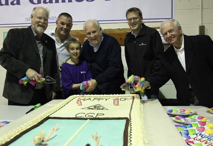 All hands on deck: It took a team to cut and distribute cake at Canada Game’s Pool’s 40th birthday party on Saturday. From left, Coun. Bill Harper, Cloud 9 bakery owner Ray Porcellato, Dylan Anderson (who shared a birthday with the pool), Mayor Wayne Wright, Coun. Jonathan Cote and Don Benson (who proposed New Westminster host the Canada Games that led to the construction of the pool) were among the 1,300 people who attended Saturday’s festivities.