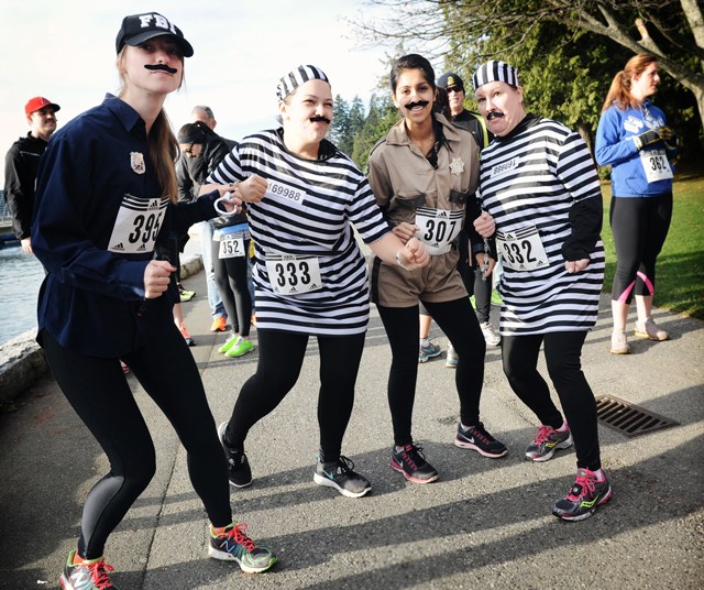 Cops and robbers also took part of the Moustache Miler held this past Saturday in Stanley Park. Sheriff Simi Banipal, with help from FBI agent Ameilia Varsava, chased after Karis Gilleran (left) and Kendall Gilleran for an entire three miles to raise money for Movember Canada. Photo by: Rebecca Blissett