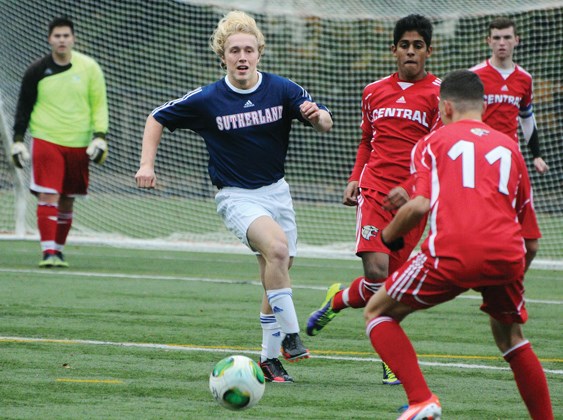Sutherland captain Cole Keffer (in blue jersey) tracks down a ball against Burnaby Central. Keffer was one of only three Grade 12 players on the Sutherland team that knocked off Burnaby 2-1 in overtime Saturday to claim the provincial AAA championship title.