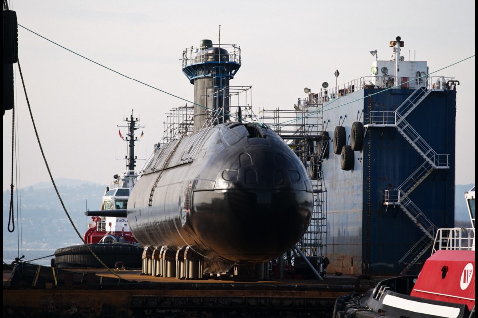 HMCS Chicoutimi arrives at Ogden Point aboard the the floating dry-dock Seaspan Careen.