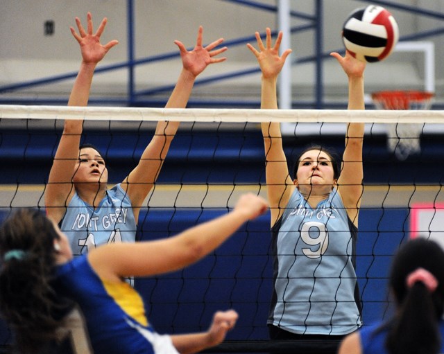 Grey Hound blockers Taeya Page (No. 14) and Natalie McCann (No. 9) defend against Seaquam in a quarterfinal match of the senior girls AAA volleyball provincials Nov. 30 in Delta.