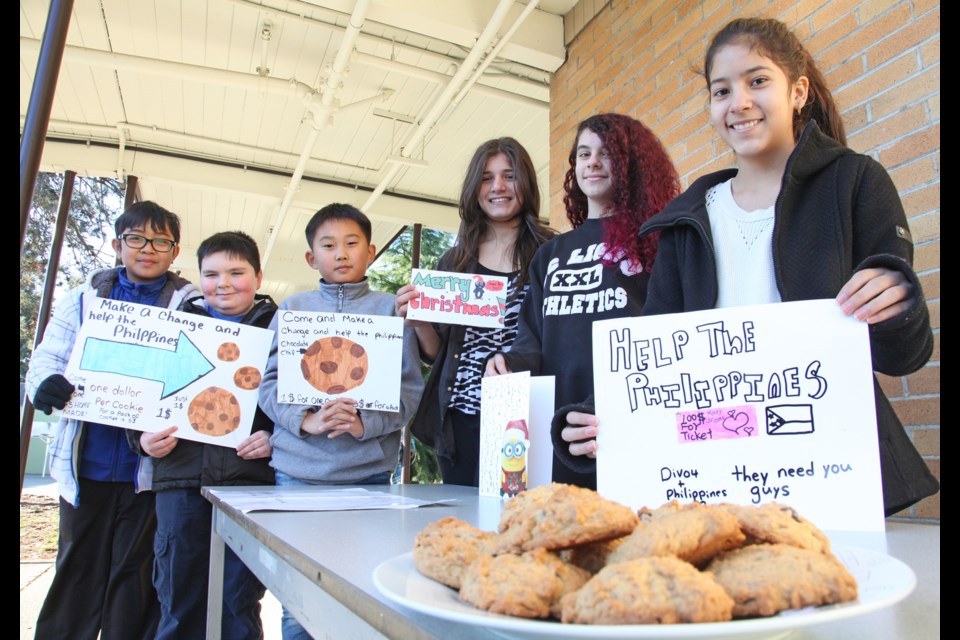 Giving time: Lord Kelvin elementary students, from left to right, Jalen Garcia, Matt Smith, Tyler Kim, Tiba Khudhur, Daisy Stylli, Velveth Mangandid recently sold cards and cookies to raise funds for those affected disaster in the Philippines.