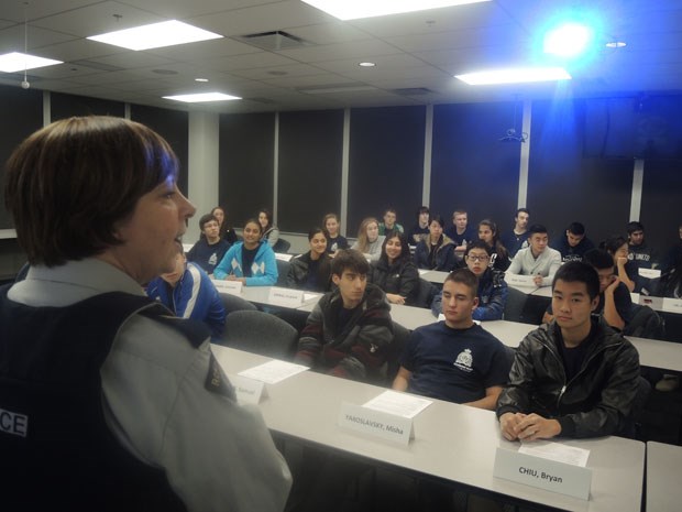 Cpl. Anette Martin talks to the youth squad before they receive their final presentation.