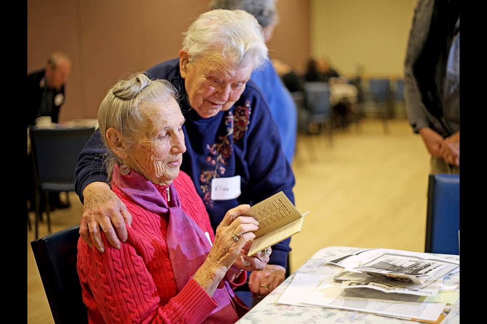 From left, Joanna Zabinsky and Elsie Ansdell look over remnants from Joanna's past as an employee for a plywood maker that supplied materials for bombers during the Second World War.