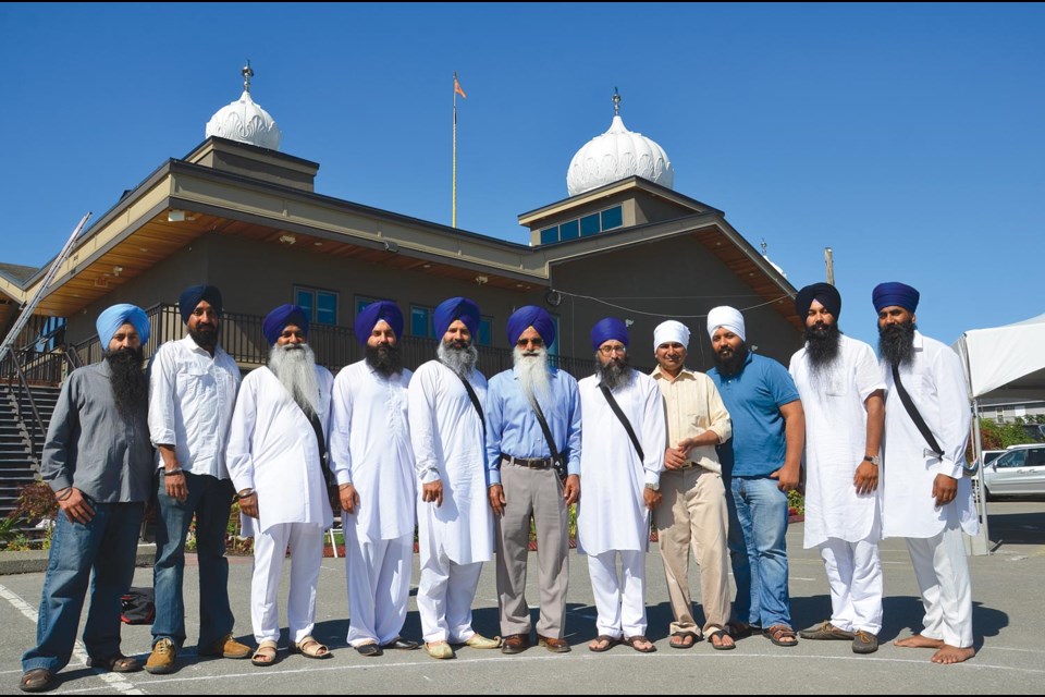 As it stands: Today the Khalsa Diwan Society executive, pictured above, manage the Gurdwara Sahib Sukh Sagar now located on Wood Street in Queensborough.