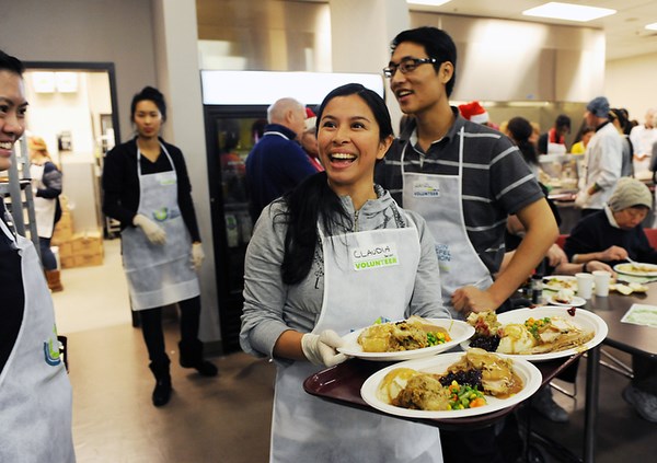 Volunteer Claudia McFadden loads up her serving tray during the Union Gospel Mission’s 73rd annual Christmas dinner at its Hastings location. Photo by: Rebecca Blissett