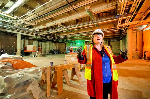 Flexible space. Vali Marling, general manager of Anvil Centre, is excited about the facility’s opening next spring. Here, she leads media on a tour of the future convention space, which can be adapted to suit a variety of needs.