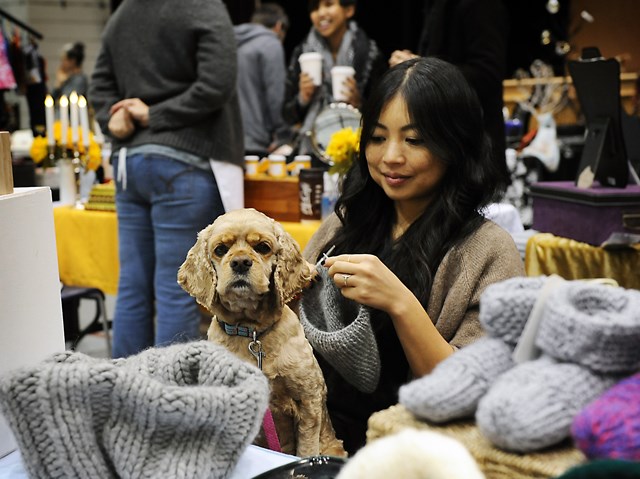 Kirsten Crisostomo manages to dogsit Tatiana for her vacationing parents as well as knit a new piece at her Kamote Handmade table during Saturday’s Blim Market at the Chinese Cultural Centre. Photo by: Rebecca Blissett