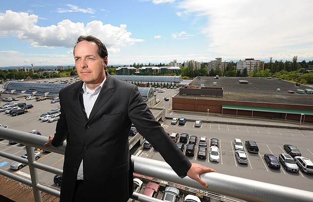 Darren Burns of Stantec Architecture stands on a balcony overlooking the expansive Oakridge parking lot. Stantec is involved in the rezoning application to redevelop the site. Photograph by: Dan Toulgoet