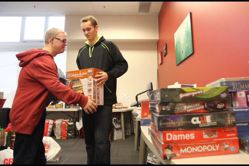 From left, Seniors Services Society volunteers Simon Vanderloo and Kevin Kingma helping with the gift deliveries.