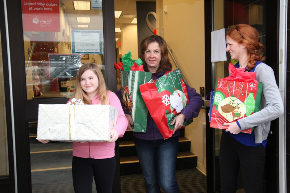 From left, Seniors Services Society volunteers Autumn Johnson, Sara Johnson and volunteer coordinator Mhairi Campbell delivering gifts to isolated seniors at Christmas.