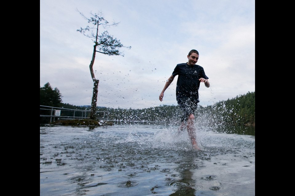 Monday: Evan Canham, 16, tests out the water at Thetis Lake for the 2014 New Year's Day polar bear swim. The annual swim and fundraiser was held at Thetis Lake due to the toxic algae at Elk-Beaver Lake.