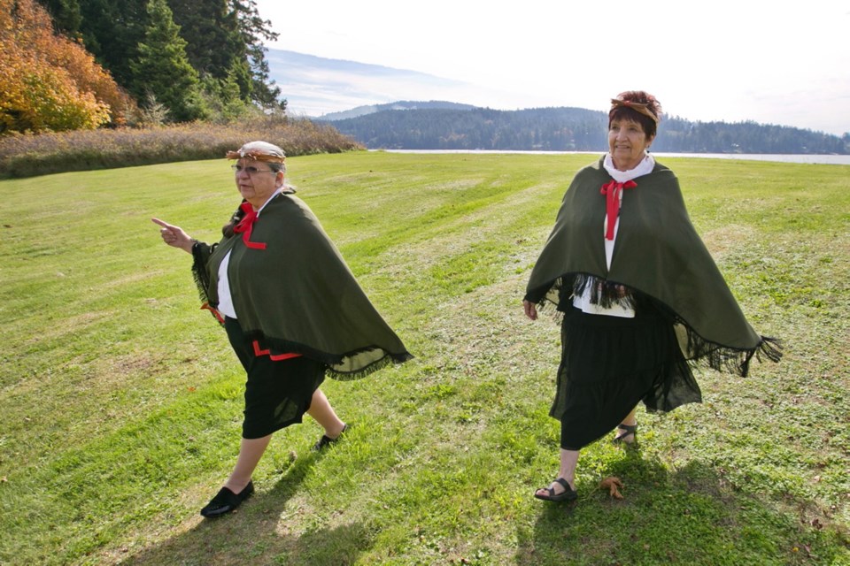 T'Sou-ke First Nation spiritual elder Shirley Alponse, left, and cultural adviser Linda George Bristol walk along the waterfront atop a shell midden where residents once harvested shellfish.