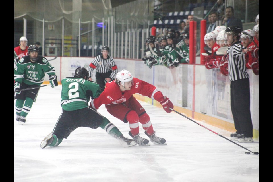 01-04-2014 SFU (red) vs North Dakota in the Great Northwest Showcase at Bill Copeland arena. photo Jason Lang