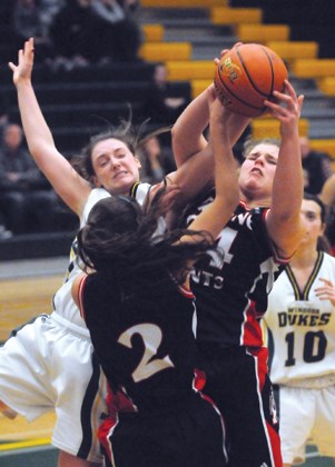 Windsor's Chantal Cumming (left) smacks into STA's Vanessa Botteselle (No. 2) and Angela Clarke during a North Shore premier league game held Dec. 19. Host Windsor won by two, avenging an earlier one-point loss to STA in the bronze medal game of the Telus Basketball Classic. STA is hosting a tournament this Thursday to Saturday.