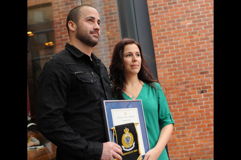 Chad Perepelkin and Brittany Skusek received a certificate of merit from Police Chief Jim Chu Wednesday for their bravery in saving a distraught man from jumping to his death at a downtown hotel. photo Dan Toulgoet