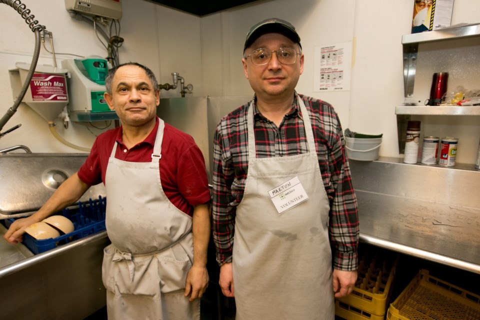 Volunteers Miki Hargas, left, and Marton Bige.