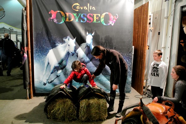 Seven-year-old Alethea Moroney straddles two saddles used for trick riding in Cavalia's Odysseo during a backstage tour Wednesday afternoon for children and youth from the CNIB. Photo: Sandra Thomas