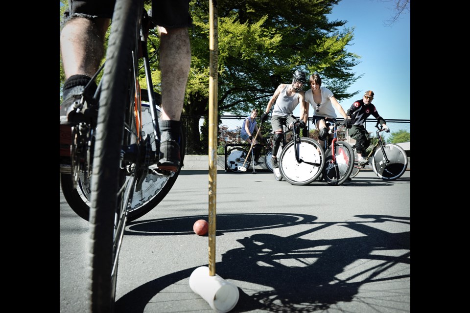Members of the East Van Bike Polo Club play on the world’s first custom-built bike polo court, which measures 38 by 20 metres, in Grandview Park on Commercial Drive. Photo: Dan Toulgoet.