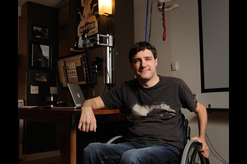 Rockclimber Brad Zdanivsky, photographed in his living room with his pulley weight system for working out, is familiar with “boosting,” which many Paralympians partake in to enhance performance. Photo Rebecca Blissett