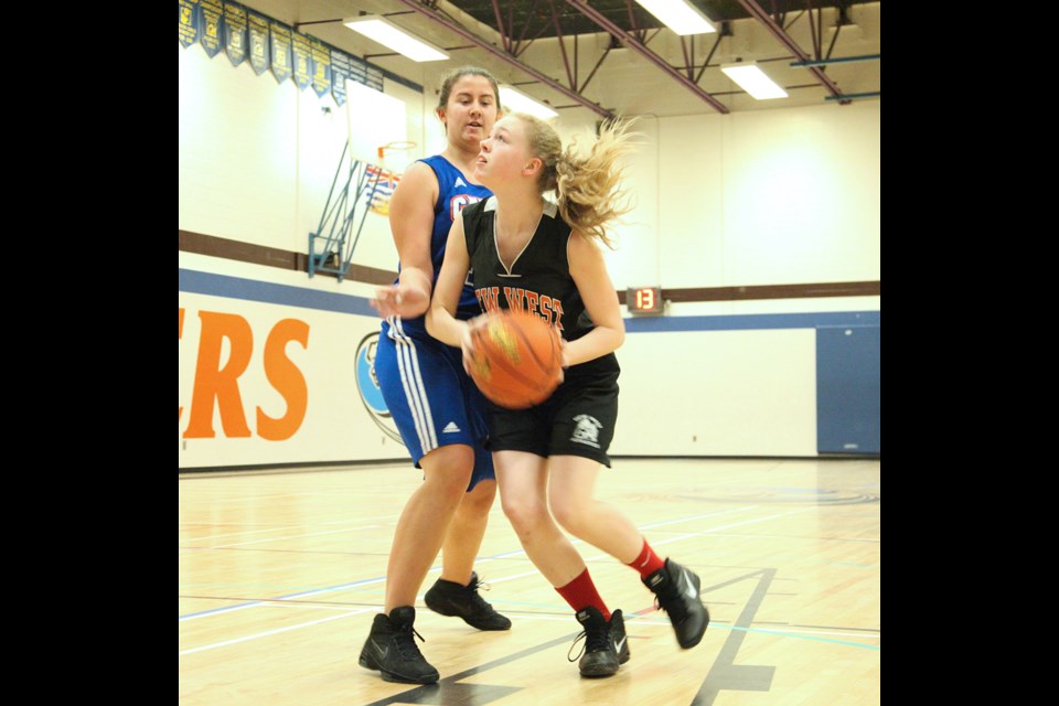 01-20-2014 New Westminster Hyacks (black) vs. Cariboo Hill in juvenile girls basketball at Cariboo Hill Secondary. Photo: Jason Lang