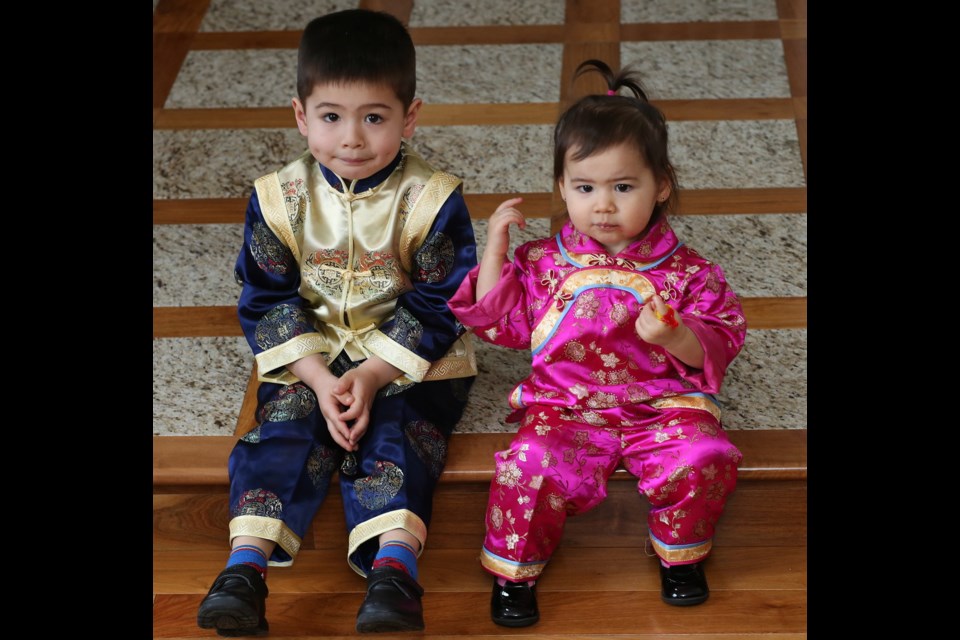 Aurora Joe, 1, and her three-year-old brother Thomas have the right clothes for Chinese New Year.