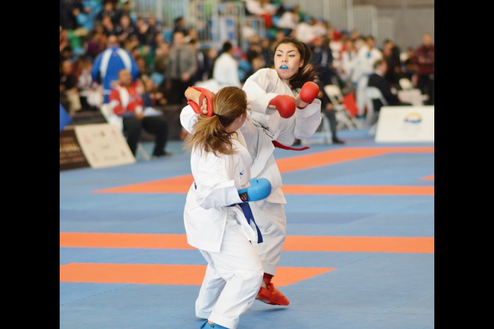 Aya Kitaoka delivers a kick to the head of an opponent at the recent National Karate Association championships in Richmond.