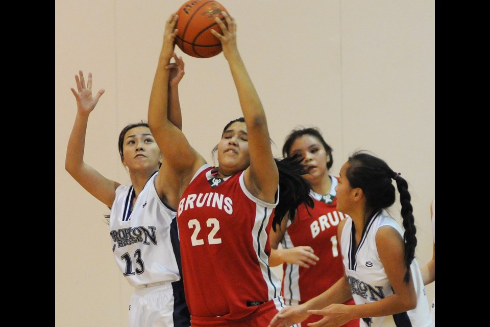 During junior girls basketball action at Crofton House secondary Thursday afternoon Britannia Bruin Aerianna Antoine (#22) and Crofton House Cougar Kat Uy struggle for the ball. Crofton House went on to win 39 – 21 to earn fourth place in the tourney standings. photo: Dan Toulgoet
