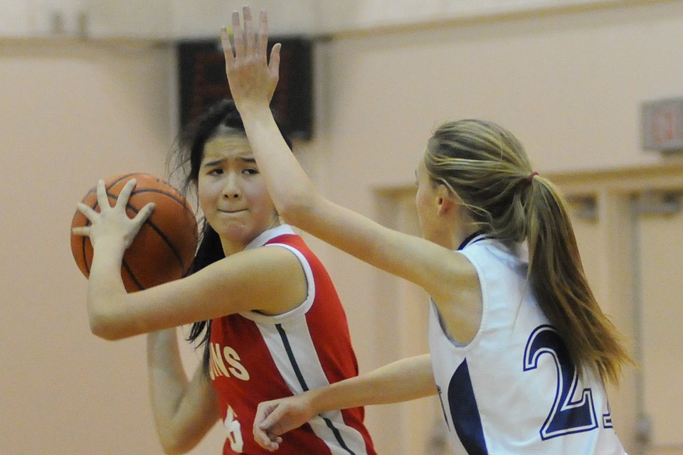 During junior girls basketball action at Crofton House secondary Thursday afternoon Britannia ball handler (#6) Mikaela Barton and Crofton House (#21) Aisling Entwistle guarding. Crofton House went on to win 39 – 21 to earn fourth place in the tourney standings. photo: Dan Toulgoet