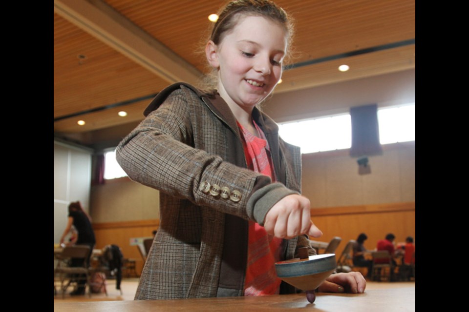 Samantha Laverton playing with "tops" at the Nikkei Centre's Family Games Day last year.