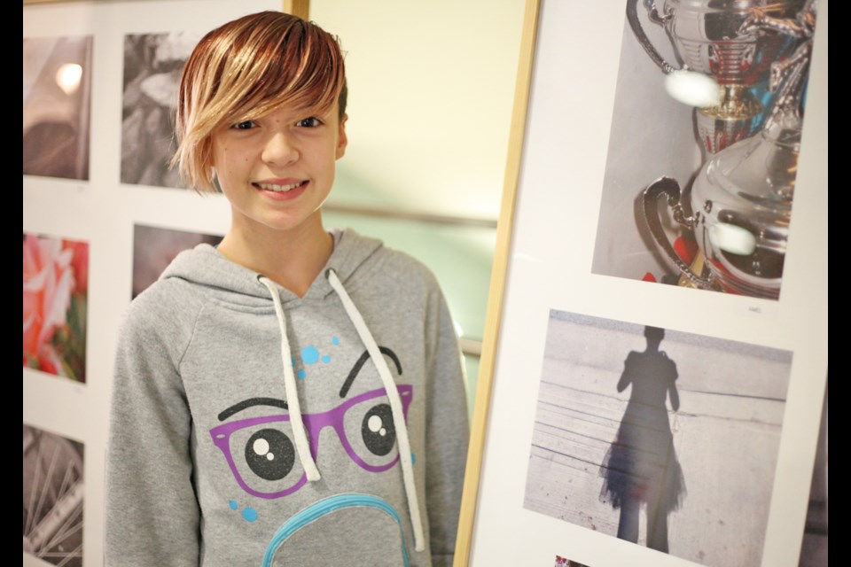 Cleo Decoin with her photo at the Edmonds Community Centre's community arts engagement project photo exhibition.