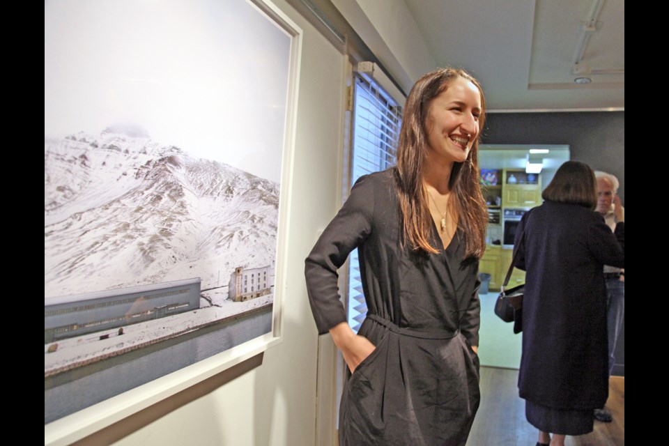 Hannah Campbell with her large-scale photos at the Arctic Fiction exhibition at Deer Lake Gallery.
