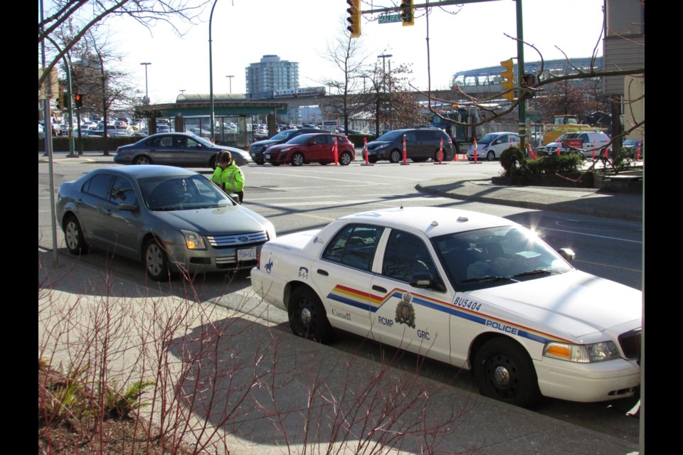Busted: Const. Diane Marsh of the Burnaby RCMP explains to a driver he is being issued a ticket for distracted driving. Burnaby RCMP is joining police across the province in a month-long campaign to raise awareness on the dangers of driving while using electronic devices.