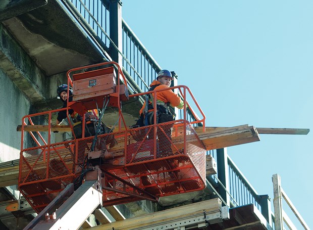 Work crews erect scaffolding on the Ironworkers Memorial Second Narrows Crossing. The bridge's sidewalks will be closed for months at a time to widen them over the next year.